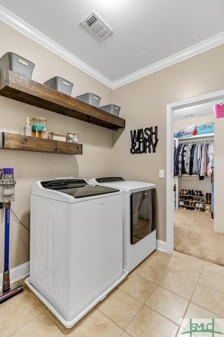 washroom with independent washer and dryer, crown molding, light tile patterned floors, light colored carpet, and baseboards
