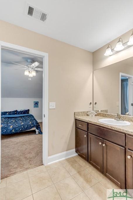 bathroom featuring tile patterned floors, vanity, connected bathroom, and baseboards