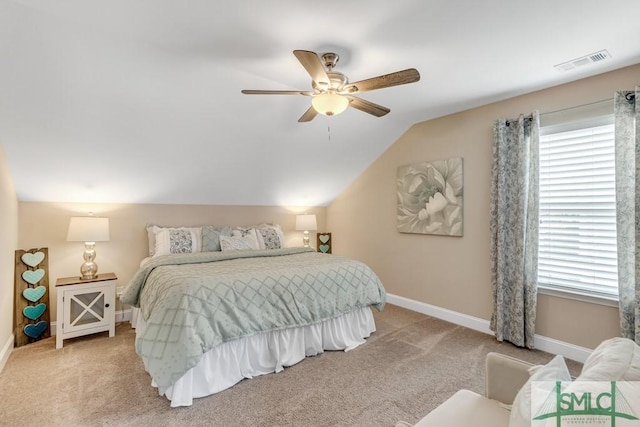 bedroom with multiple windows, light carpet, baseboards, vaulted ceiling, and a ceiling fan
