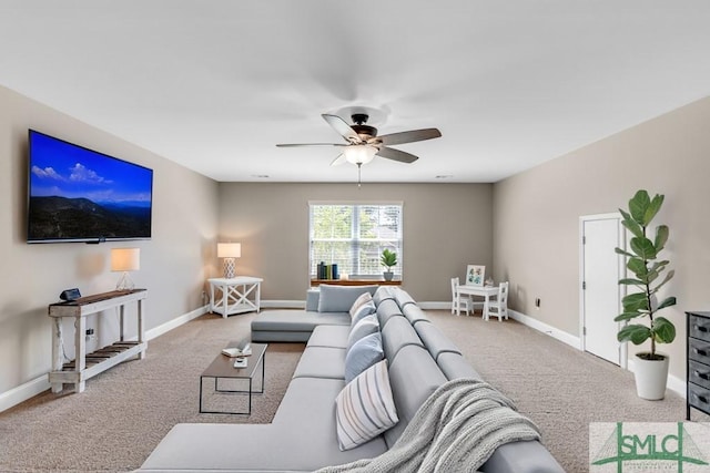 carpeted living room with a ceiling fan and baseboards