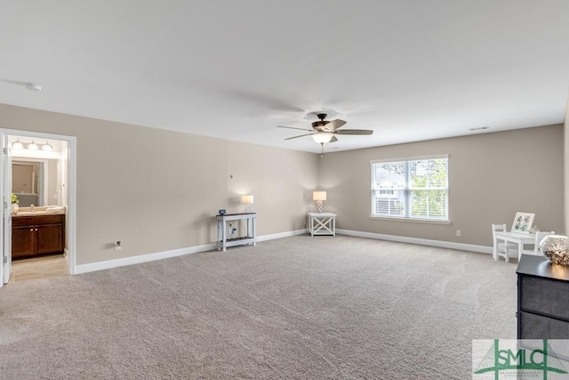 unfurnished room featuring ceiling fan, light carpet, and baseboards