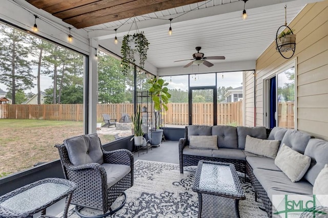 sunroom featuring outdoor lounge area and a ceiling fan