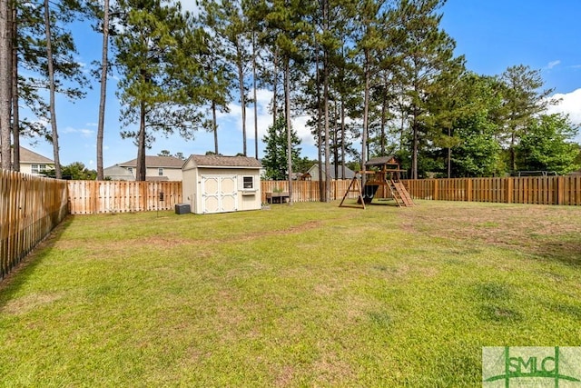 view of yard with a storage unit, a playground, and an outdoor structure