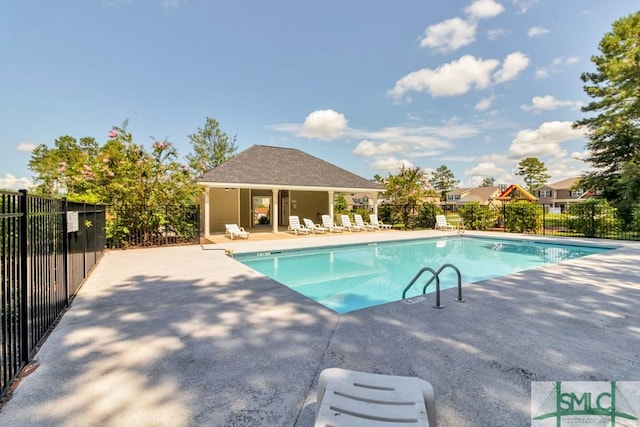 community pool featuring fence and a patio area