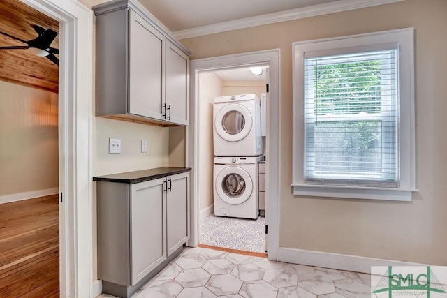 417 E 61st St, Savannah, GA 31405 - clothes washing area with stacked washer and clothes dryer, ceiling fan, ornamental molding, and baseboards