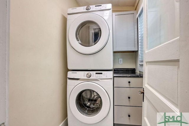 417 E 61st St, Savannah, GA 31405 - clothes washing area featuring cabinet space and stacked washer and clothes dryer