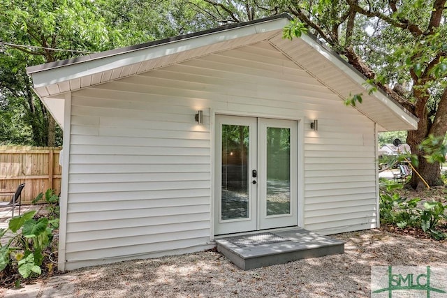 417 E 61st St, Savannah, GA 31405 - view of outdoor structure with french doors, fence, and an outbuilding