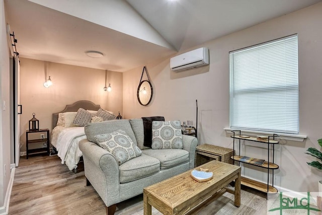 417 E 61st St, Savannah, GA 31405 - bedroom featuring a wall mounted air conditioner, light wood-style flooring, lofted ceiling, and baseboards