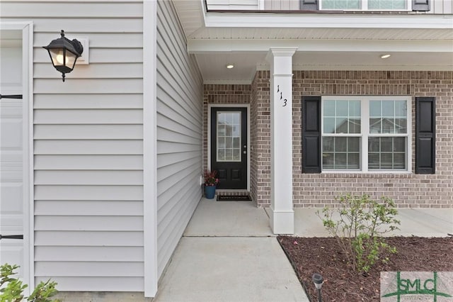 property entrance with brick siding
