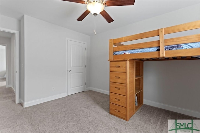 unfurnished bedroom with carpet, baseboards, and ceiling fan