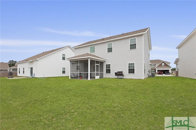 back of property featuring a sunroom and a yard