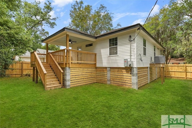 rear view of house featuring ceiling fan, stairway, a deck, and central AC
