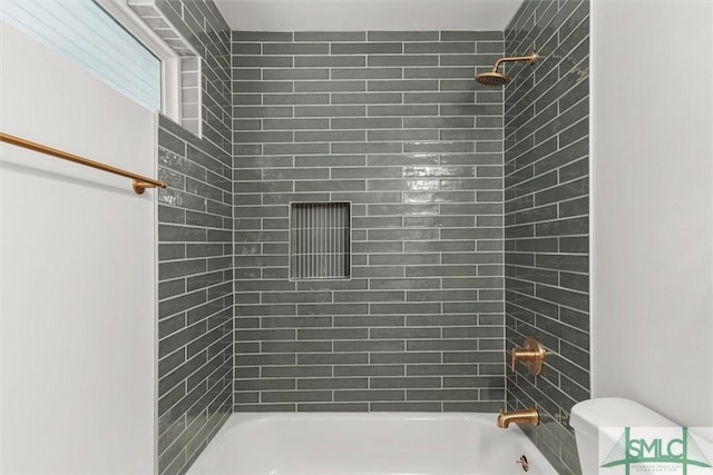 bathroom featuring shower / bathtub combination and toilet