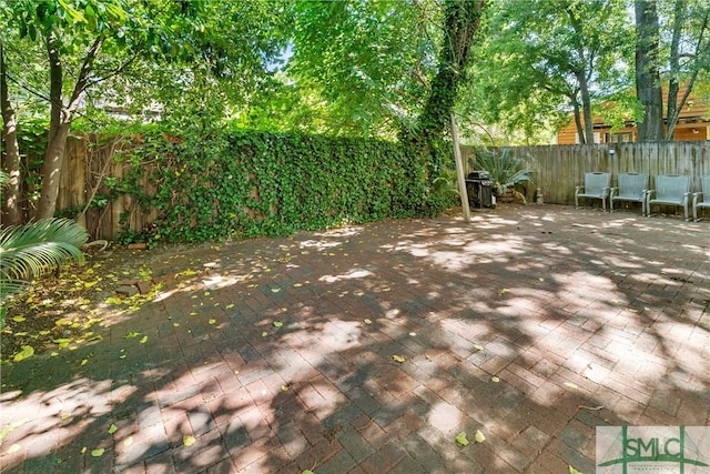 524 Nicoll St, Savannah, GA 31401 - wooden terrace featuring a patio area, a fenced backyard, and grilling area