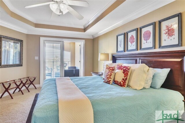 carpeted bedroom featuring a tray ceiling, access to exterior, crown molding, and ceiling fan