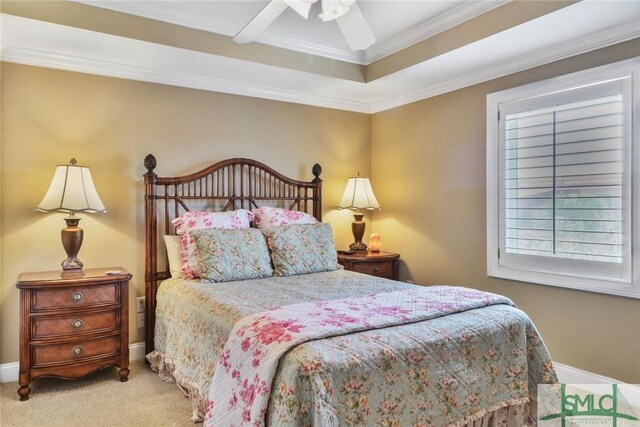 bedroom with carpet, ornamental molding, a raised ceiling, a ceiling fan, and baseboards