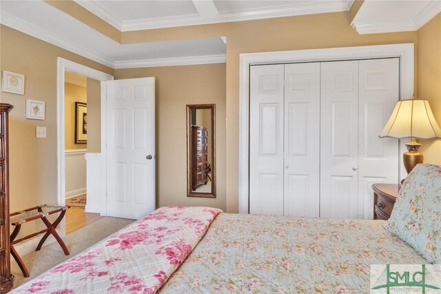 bedroom with a closet and ornamental molding