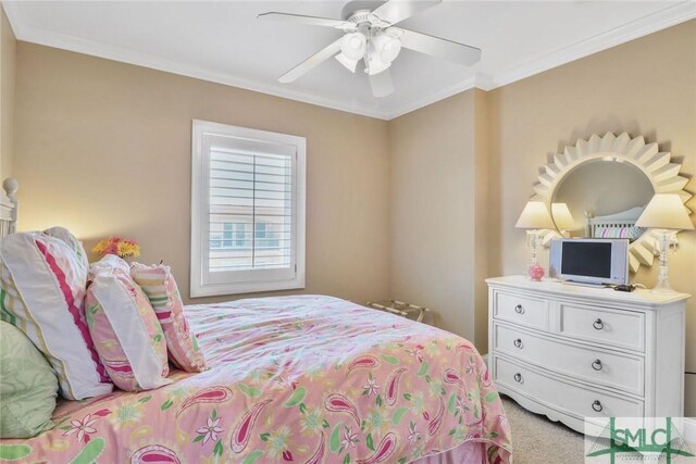 carpeted bedroom featuring crown molding and a ceiling fan