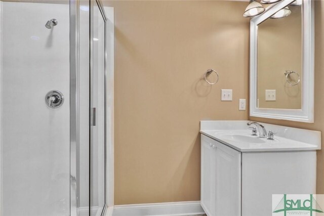 bathroom with a stall shower and vanity