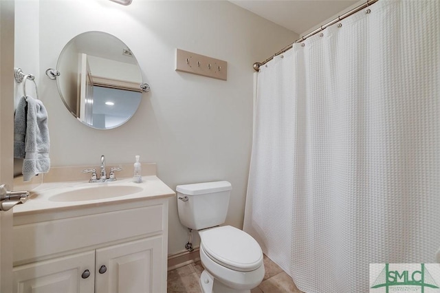 bathroom featuring toilet, tile patterned floors, vanity, and a shower with curtain