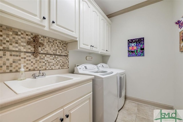 laundry room featuring independent washer and dryer, cabinet space, baseboards, and light tile patterned floors