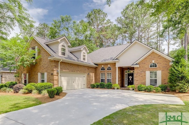 view of front of home featuring brick siding, concrete driveway, a front yard, a garage, and roof with shingles
