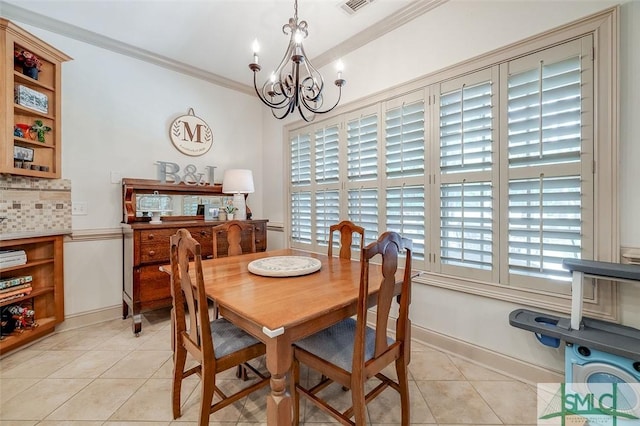 dining space featuring a chandelier, light tile patterned floors, ornamental molding, and baseboards