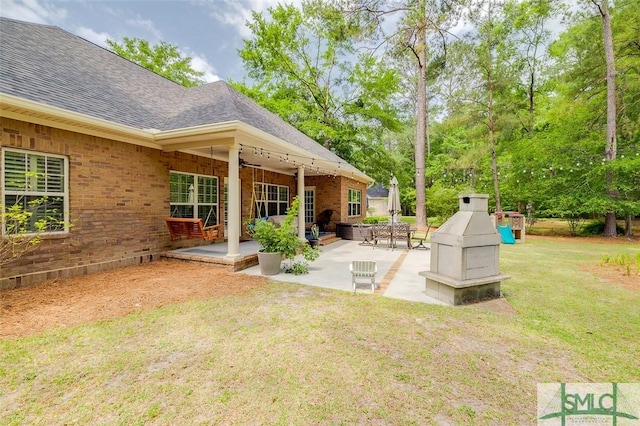 view of grassy yard featuring a patio area and a ceiling fan