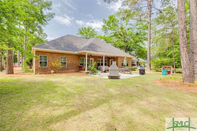 back of house with a patio area, a yard, a shingled roof, and a ceiling fan