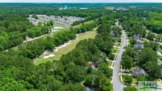 aerial view of property's location with a heavily wooded area and a nearby body of water