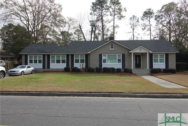 single story home featuring a front lawn and a chimney