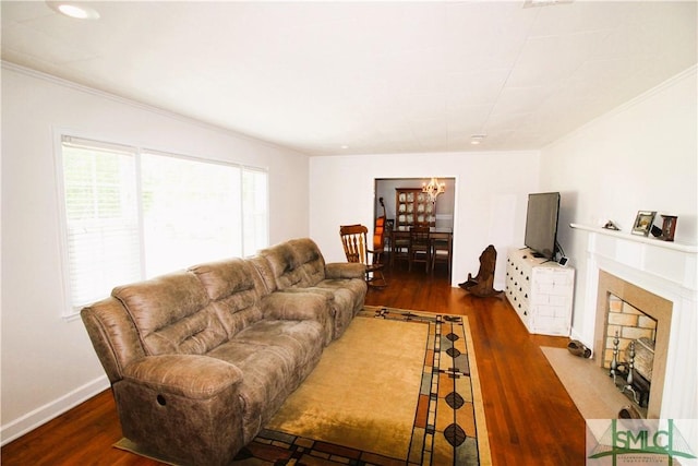 living room featuring a chandelier, wood finished floors, crown molding, a fireplace with flush hearth, and recessed lighting
