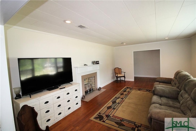 living area featuring ornamental molding, dark wood finished floors, a fireplace with flush hearth, baseboards, and recessed lighting