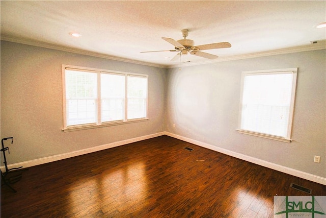 spare room featuring ornamental molding, dark wood finished floors, baseboards, and ceiling fan