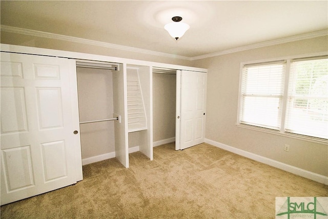unfurnished bedroom featuring ornamental molding, light carpet, and baseboards