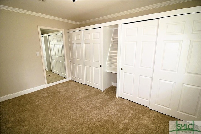 unfurnished bedroom with multiple closets, carpet floors, crown molding, and baseboards