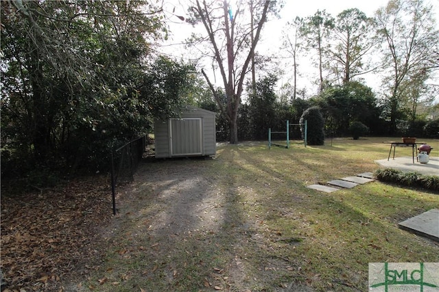 view of grassy yard with a storage shed and an outbuilding