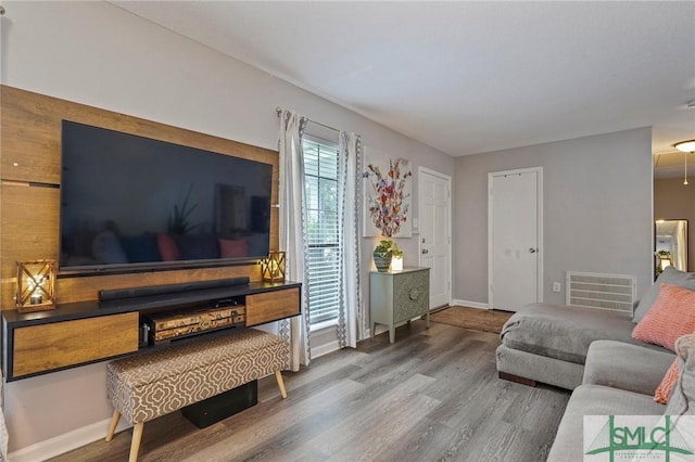 living room with wood finished floors and baseboards