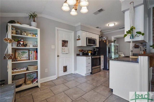 kitchen with stainless steel appliances, a sink, crown molding, white cabinetry, and a chandelier