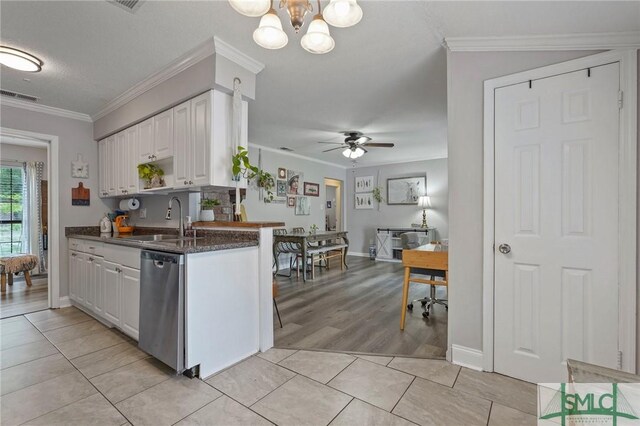kitchen featuring a sink, stainless steel dishwasher, white cabinets, ceiling fan, and a chandelier