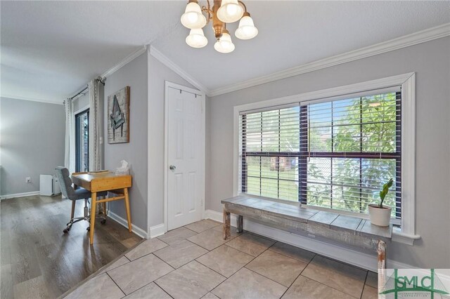 dining space with a chandelier, ornamental molding, baseboards, vaulted ceiling, and wood finished floors