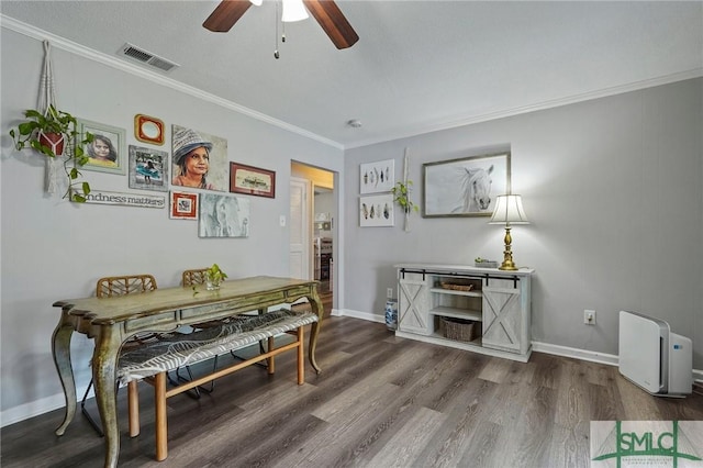 dining room featuring crown molding, dark wood-style flooring, ceiling fan, and baseboards