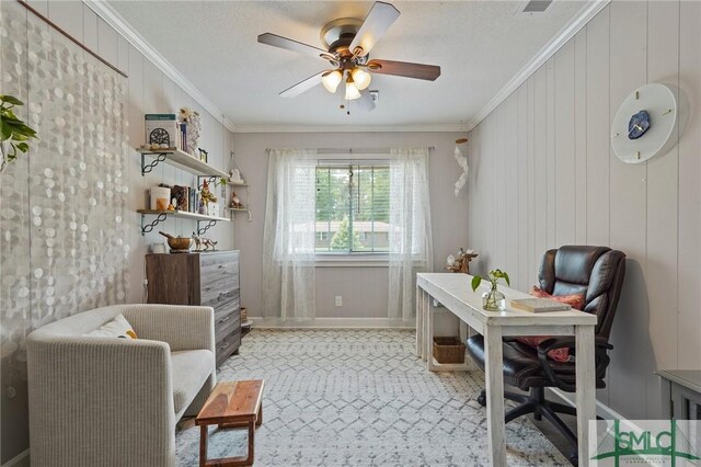 office space featuring crown molding, a ceiling fan, and baseboards