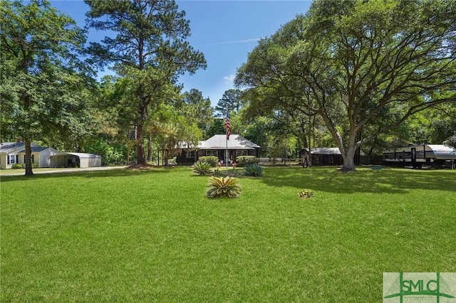 309 E 5th St, Rincon, GA 31326 - view of grassy yard with view of scattered trees