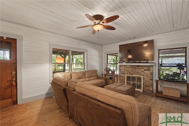 309 E 5th St, Rincon, GA 31326 - living room featuring hardwood / wood-style flooring, plenty of natural light, wood ceiling, a ceiling fan, and a brick fireplace