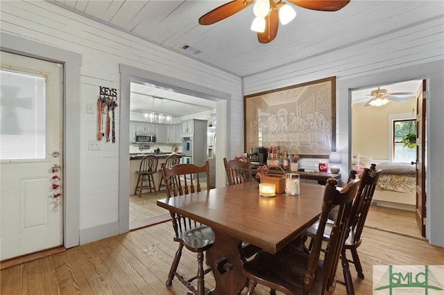 309 E 5th St, Rincon, GA 31326 - dining space with light wood-style floors, a ceiling fan, and wooden walls