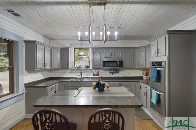 309 E 5th St, Rincon, GA 31326 - kitchen featuring gray cabinetry, appliances with stainless steel finishes, dark countertops, a sink, and wood ceiling
