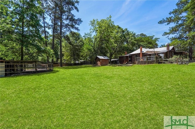 309 E 5th St, Rincon, GA 31326 - view of yard with an outdoor structure and a shed