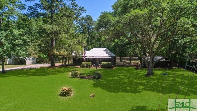 309 E 5th St, Rincon, GA 31326 - view of grassy yard with an outbuilding and a shed