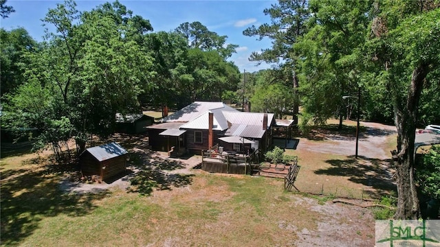 309 E 5th St, Rincon, GA 31326 - view of green lawn featuring a storage unit, a wooden deck, and an outdoor structure